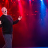 dan jahn on stage with red and blue lights